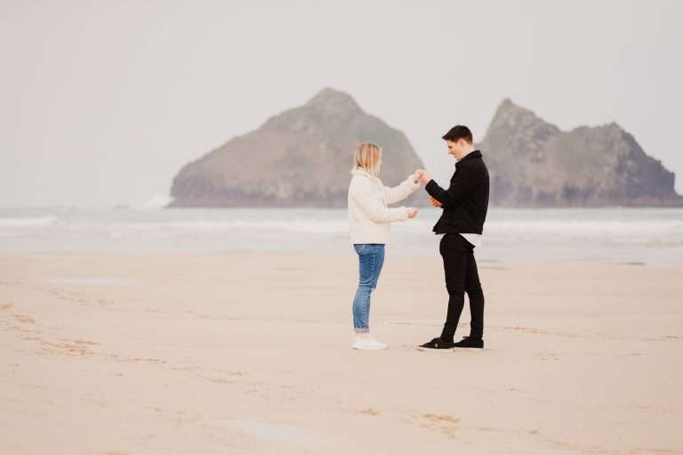 Checking out the engagement ring 
Proposal in Cornwall at Holywell Bay, Cornwall, UK