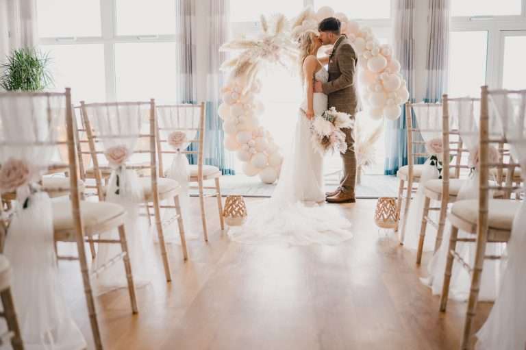 Bride and Groom kiss during their Styled wedding at Above The Bay