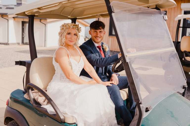Wedding couple enjoying the golf buggy ride at Above The Bay