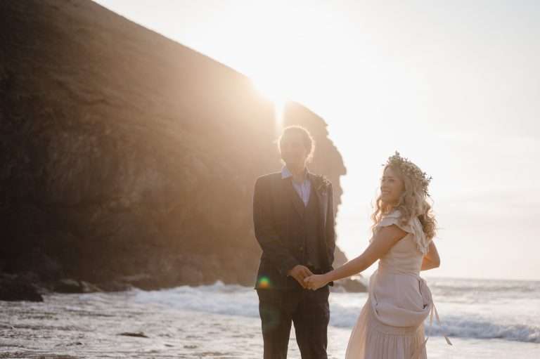 Wedding VS Elopement - The Difference - Bride and Groom on the beach at Chapel Porth, Cornwall, celebrating their elopement