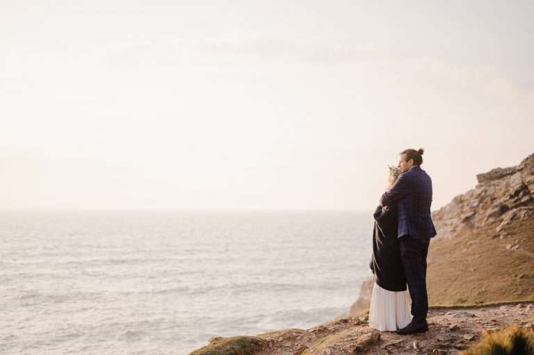 Standing on the edge and looking out to sea over the beautiful Cornwall landscape - 5 Wedding Planning Apps You Need