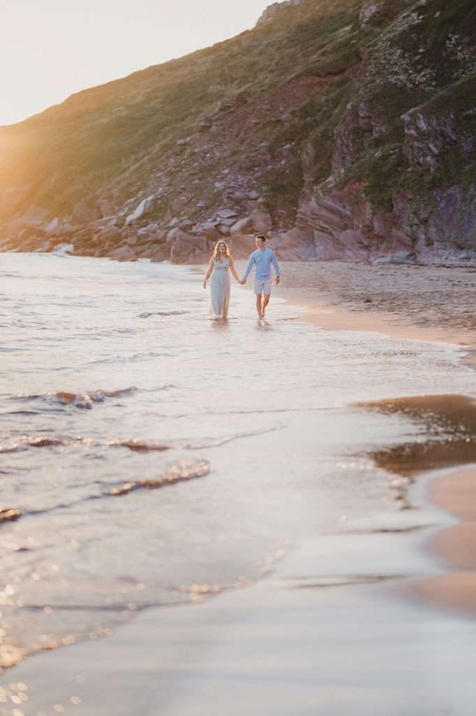 Best Locations for an Engagement Photoshoot in Cornwall | Cornwall Wedding Photographer | Couple walking along a beach