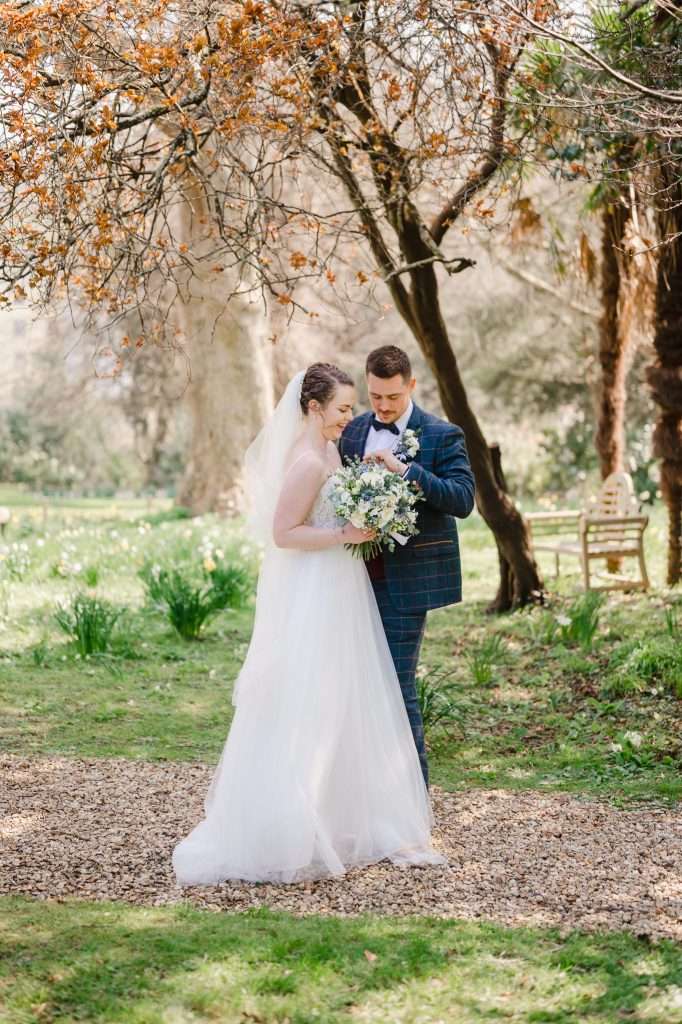 Couple admiring their wedding rings - 14 Tips to Help You Find the Perfect Wedding Dress 