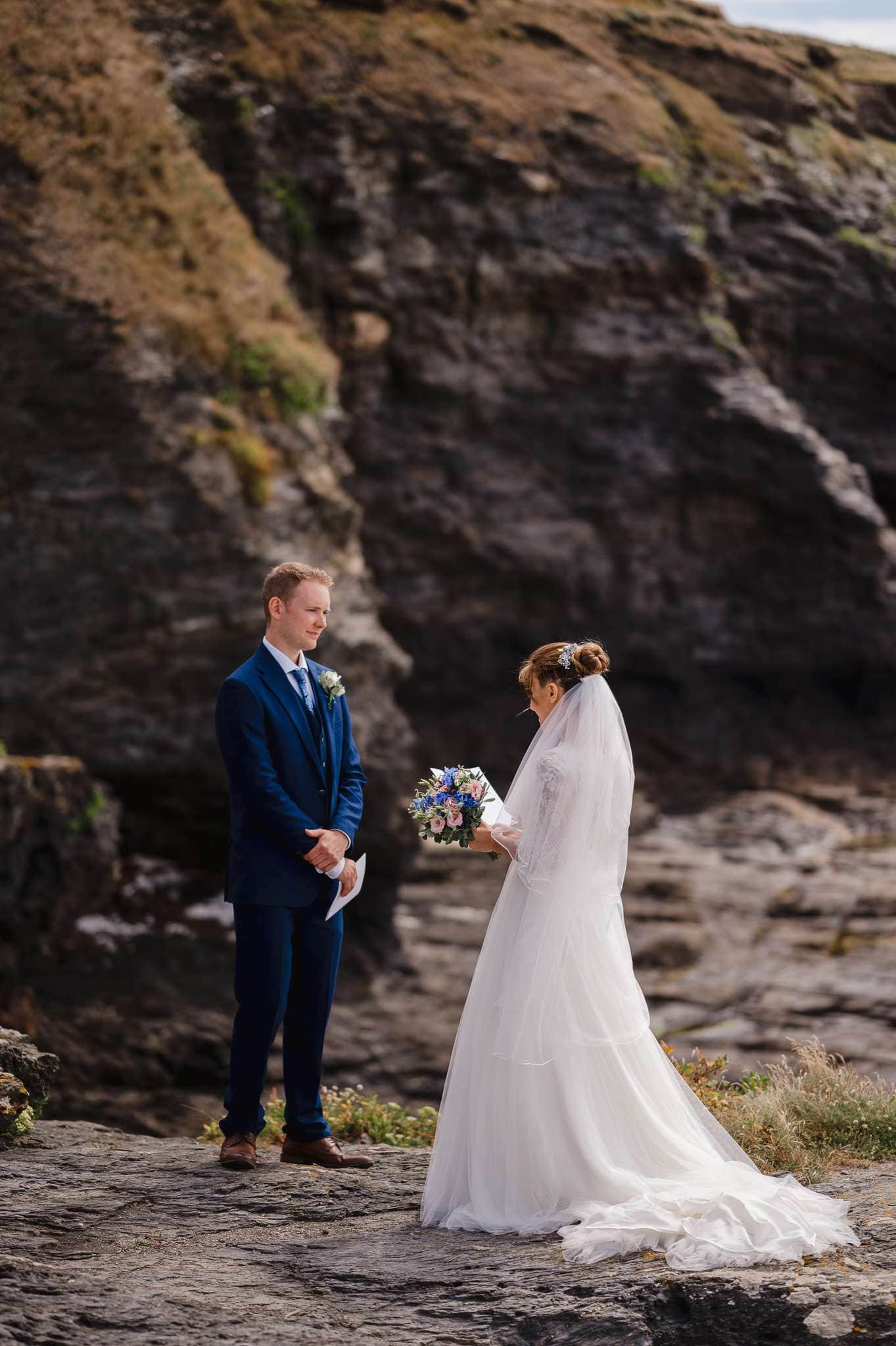 Couple saying their vows on the rocky shore of Beacon Crag - Wedding VS Elopement - The Difference