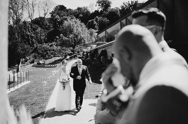 Making an entrance to their wedding ceremony as the grooms shows his emotions - The Question You Need To Ask Your Wedding Venue