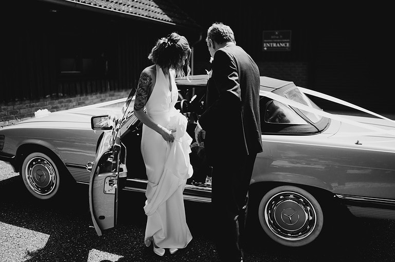 Bride making an entrance to her wedding at Froginwell wedding venue - The Questions To Ask Your Wedding Venue