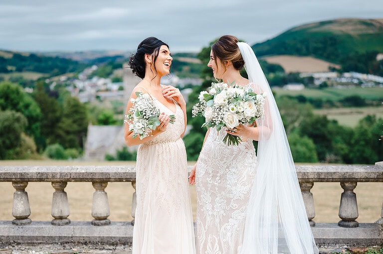 Bride and bridesmaid enjoying a moment - Hot To Pick The Perfect UK Wedding Venue