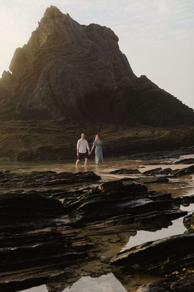 Jake and Layla celebrating their engagement with a photoshoot on a dramatic beach in Portugal - The Perfect Engagement: Your Ultimate Guide To Plan Your Unique Proposal