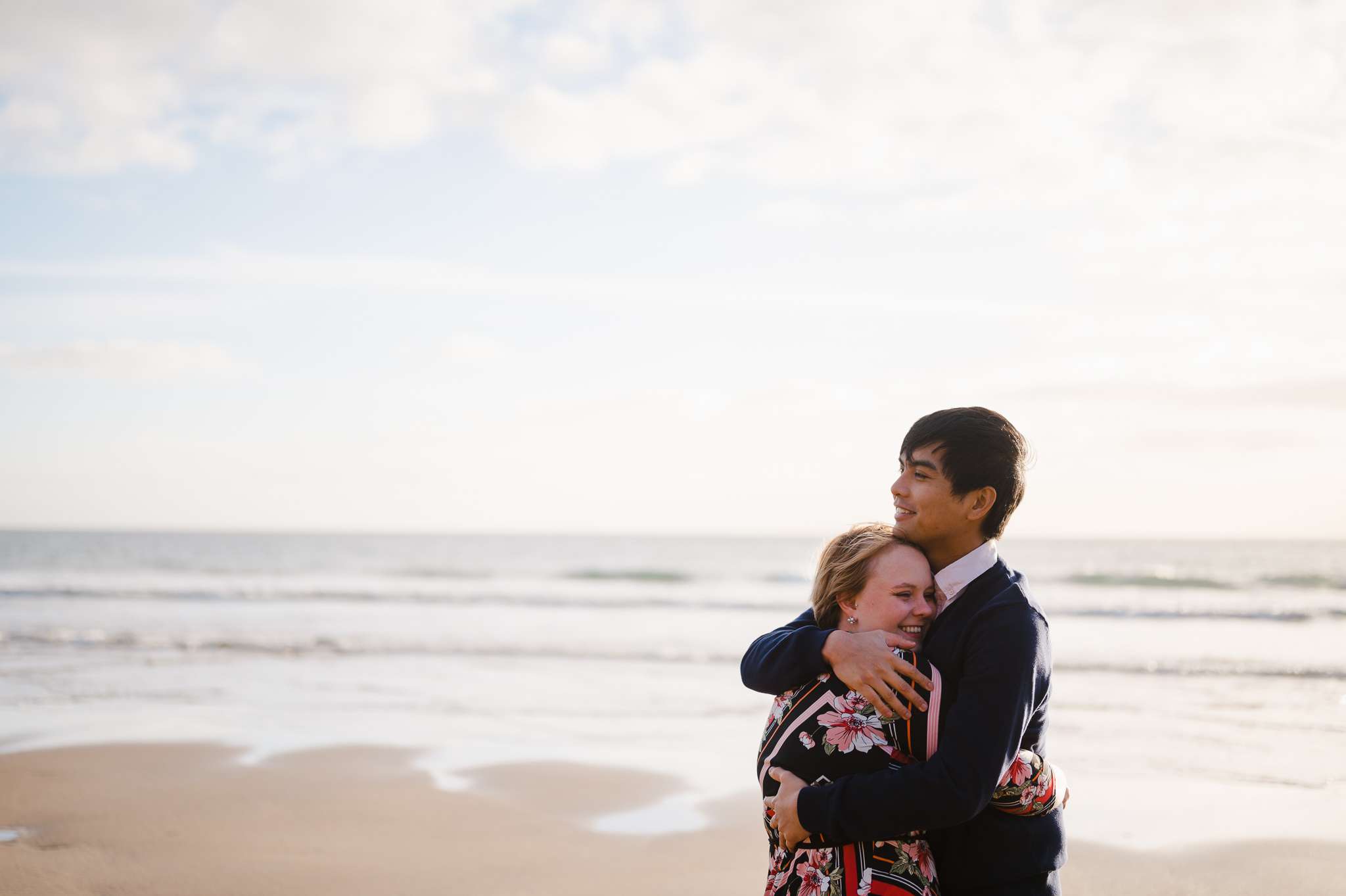 Couple Hugging On Sandy Cove Beach in Cornwall - The Perfect Engagement: Your Ultimate Guide To Plan Your Unique Proposal