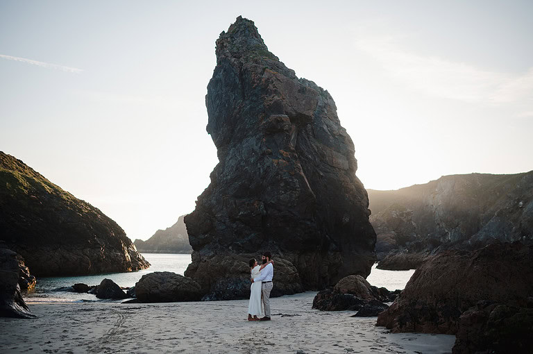 Happy couple celebrating getting engaged with a photoshoot after their wedding proposal at Kynance Cove