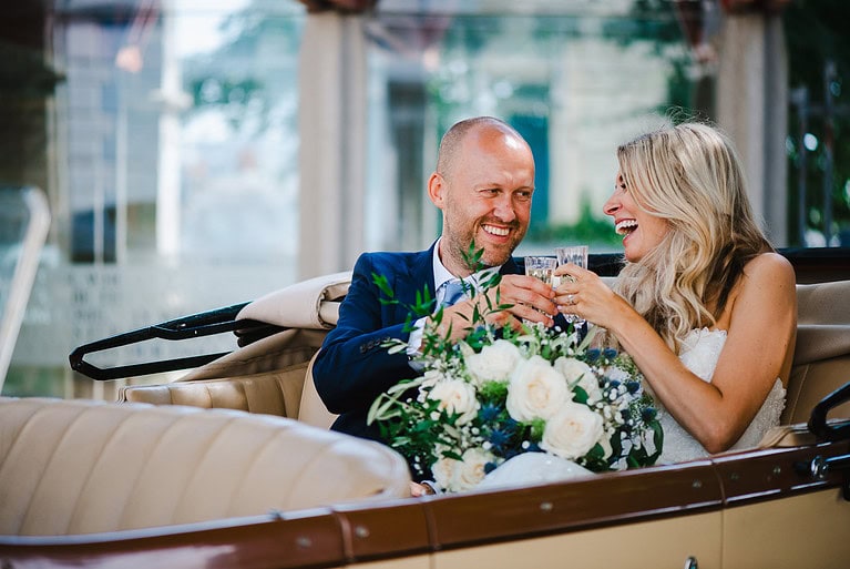 Just married and on their way to Polhawn Fort after sharing a few laughs and a glass of bubbly in the back of a vintage car