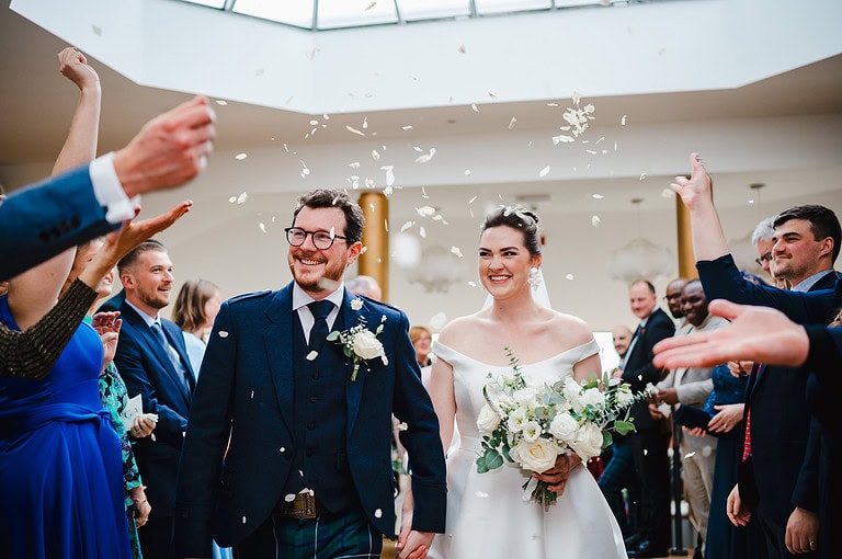 wedding confetti being thrown inside at the Polurrian On The Lizard