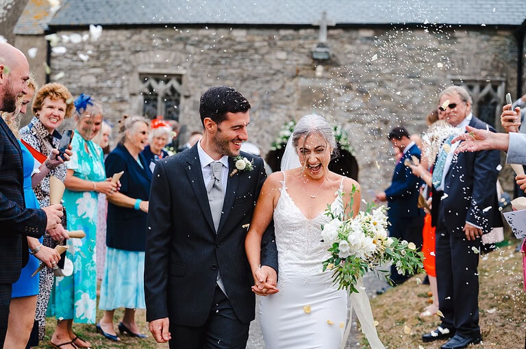 Wedding Confetti Petals covering the couple as they walk down the confetti aisle