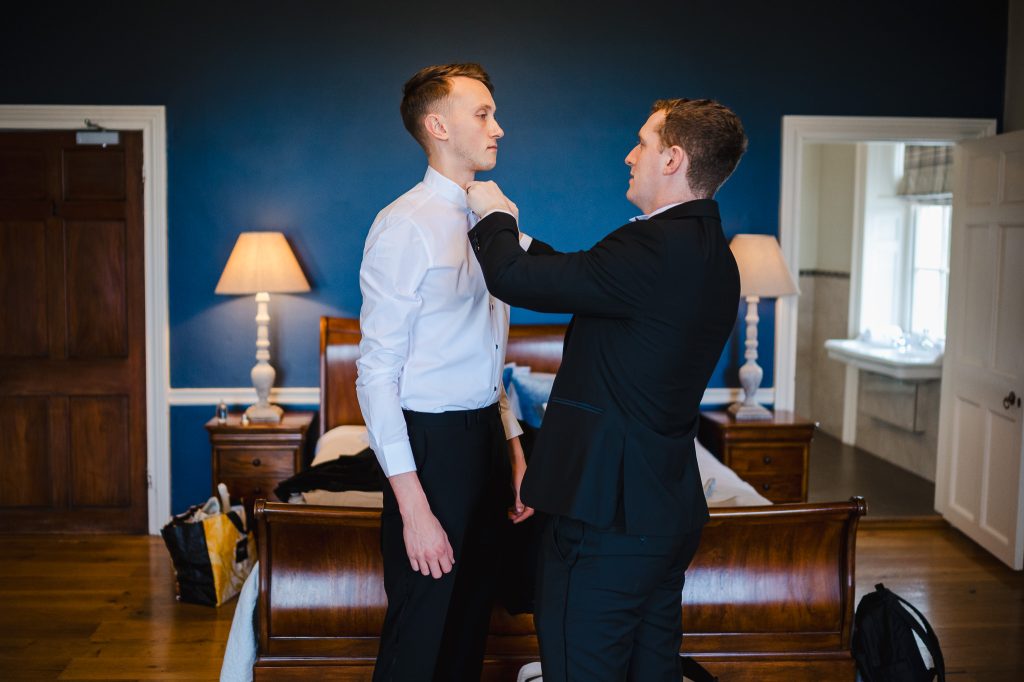 Groom and his party getting ready to celebrate the grooms wedding at Rockbeare Manor
