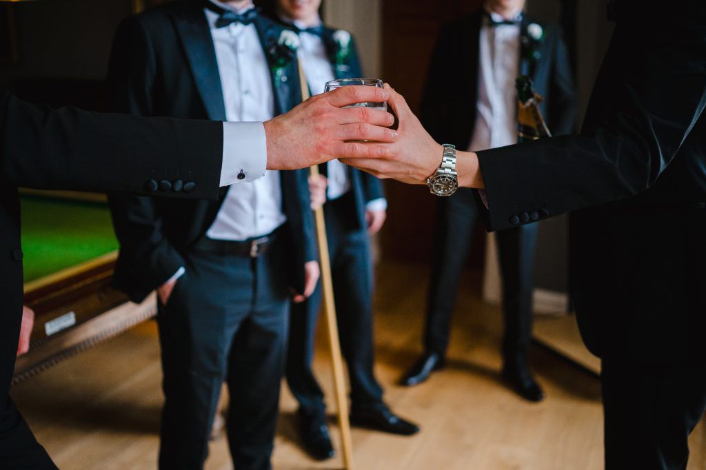 Groom and his party getting ready to celebrate the grooms wedding at Rockbeare Manor