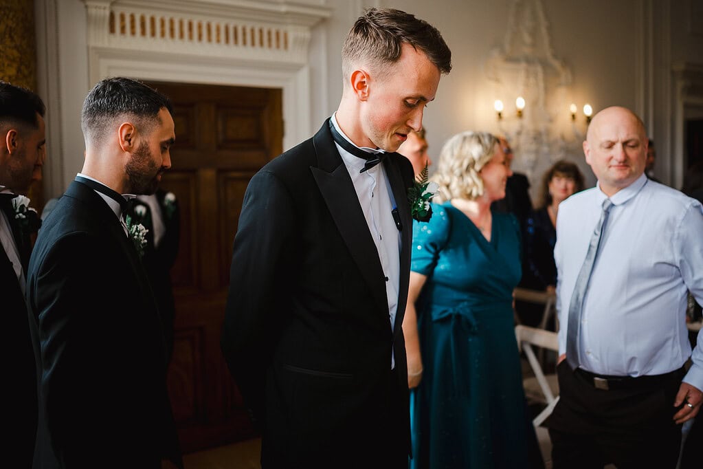 Groom waiting for his bride at the end of the asile
