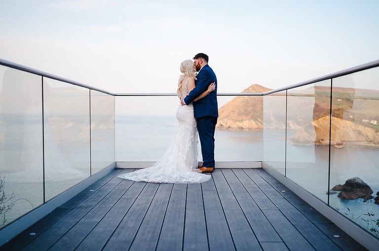 Standing on a balcony overlooking the sea in Devon - Creating A Unique Wedding Venue