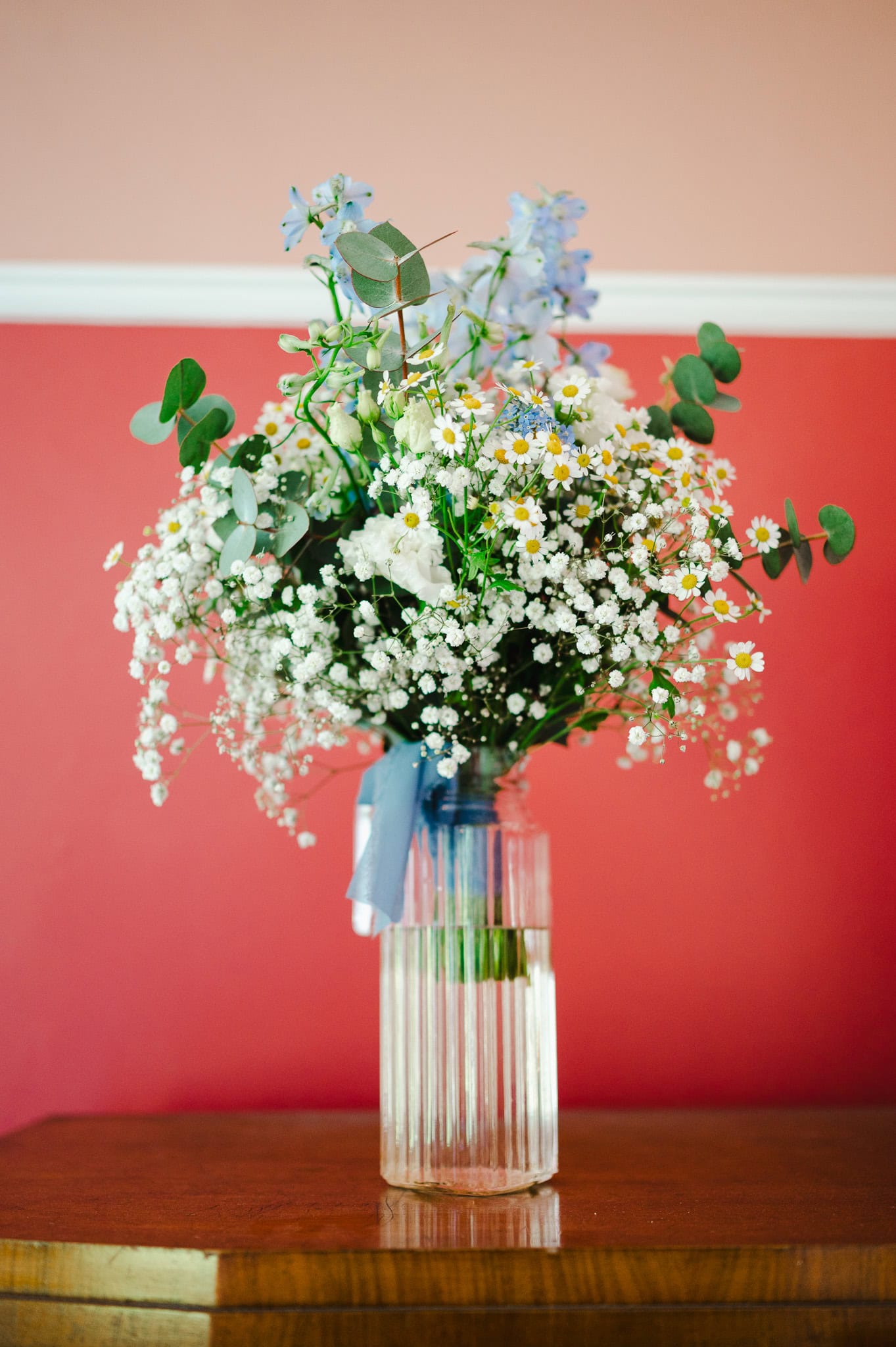 Wedding Flowers against a red wall