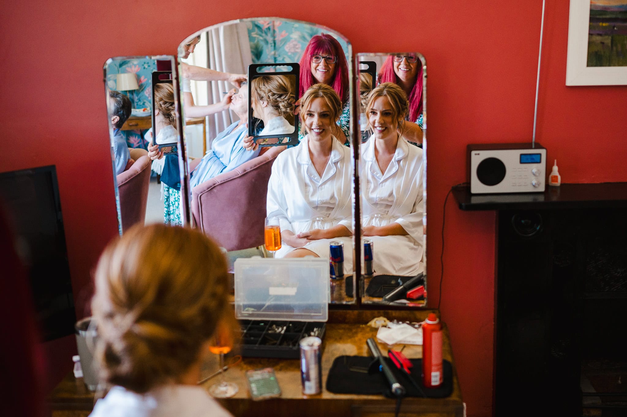 Looking into the mirror at their Getting hair ready for the bride