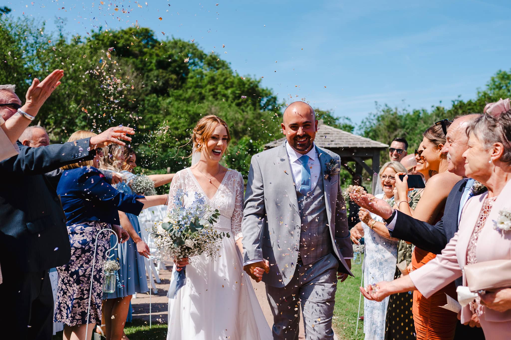 Confetti time on the happy couples wedding day at Sandy Cove