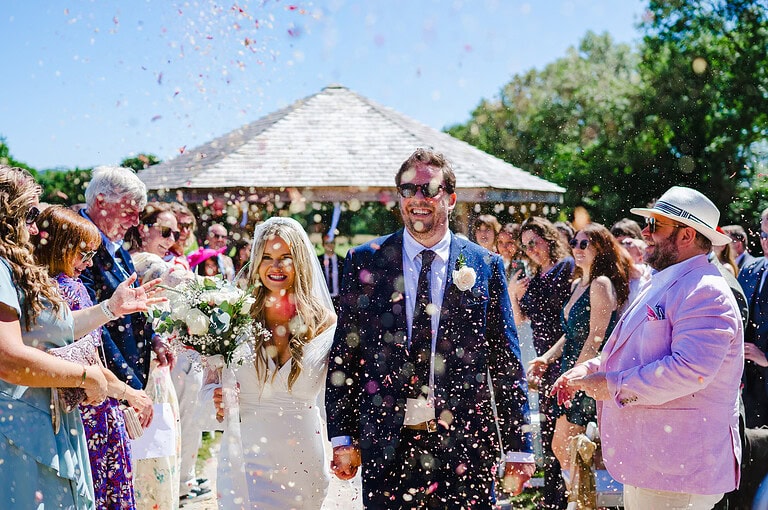 Lots of Confetti thrown as the happy couple walk back down the aisle