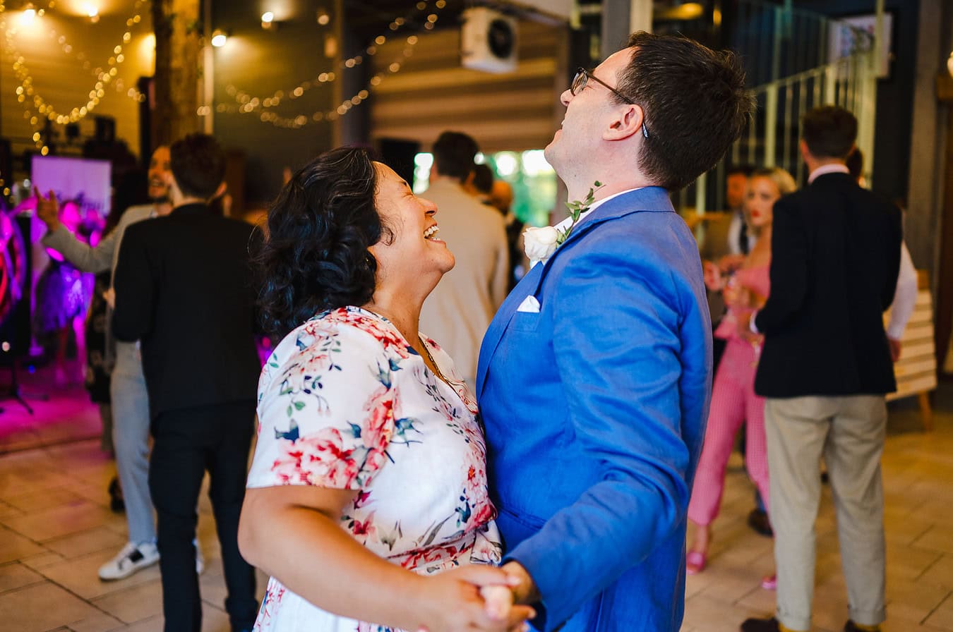 Wedding guests laughing on the dance floor