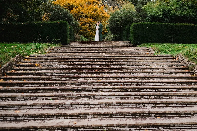 Wedding couple on top of steps kissing - Autumn Wedding Ideas