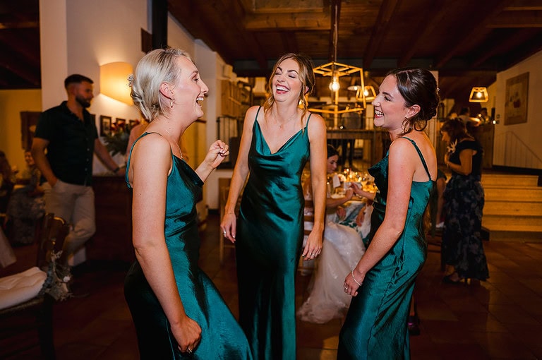 Bridesmaids laughing at the wedding reception