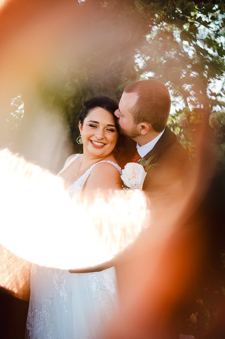 Aritistic wedding photo taken by Cornwall Wedding photographer, Jake Timms Photography - Home Page - Groom kisses bride on the forhead