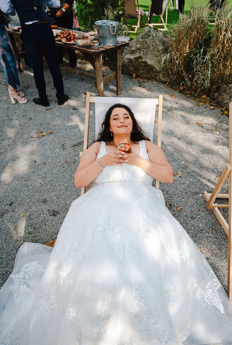 The bride taking a moment to relax and unwind on a beach chair