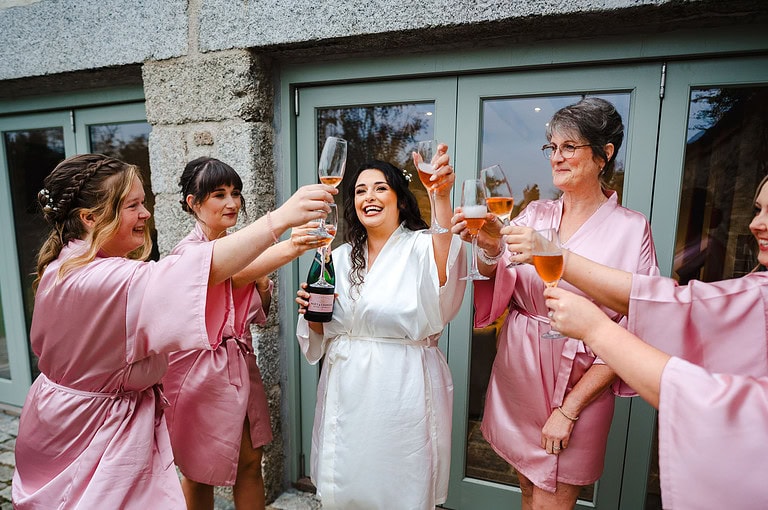 bridal party cheers with prosecco