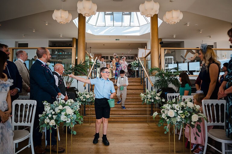 Flower boys and girls enter the wedding ceremony