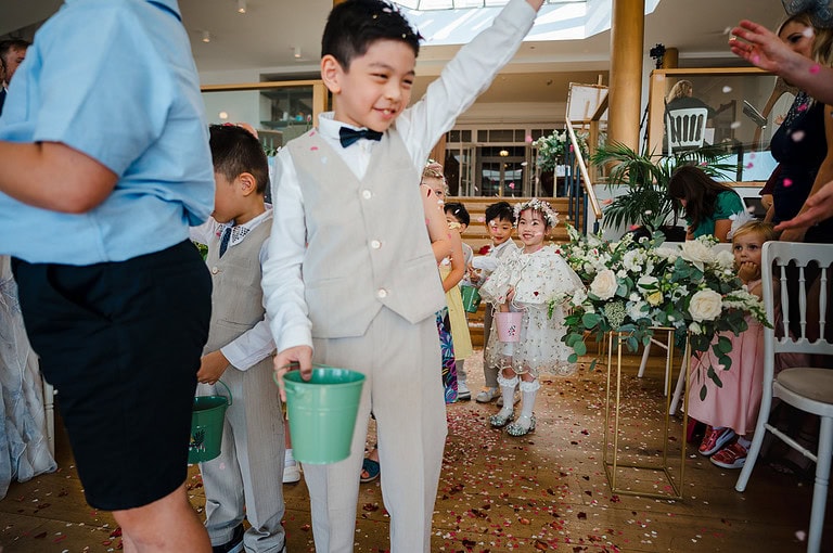 flower petals being thrown over the ceremony entrance way