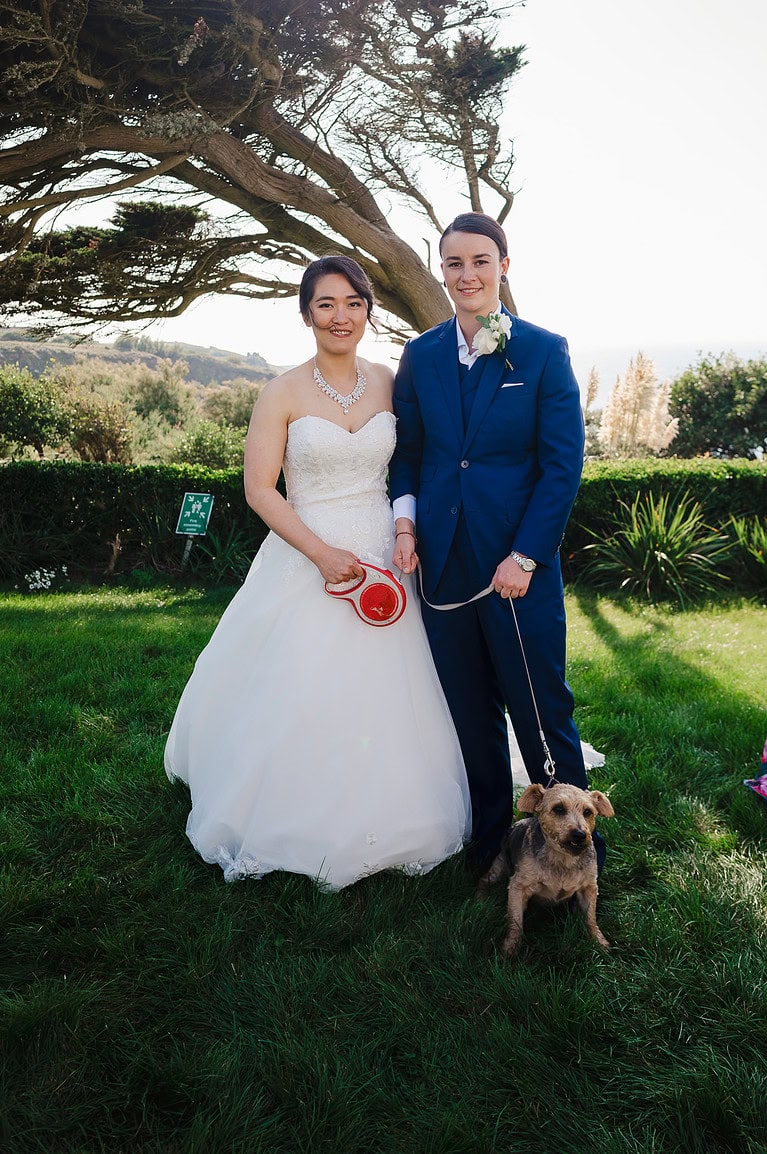 The happy couple pose with their dog