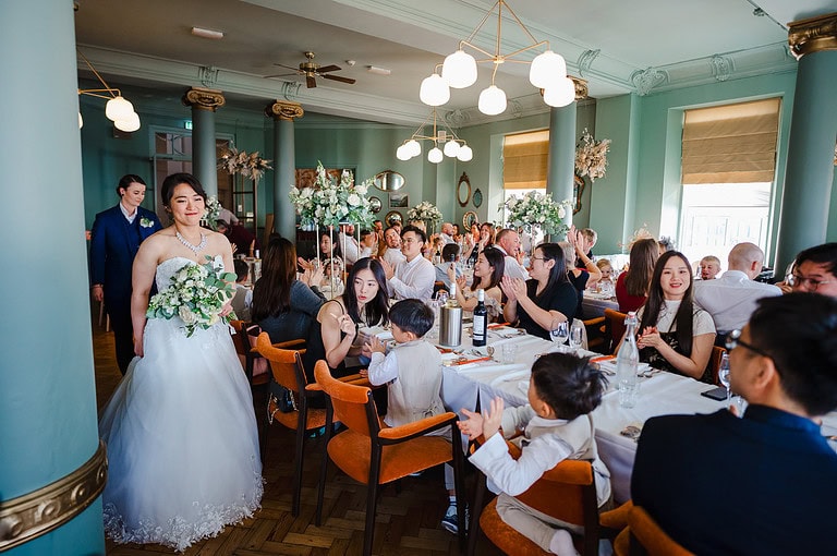 The newlyweds enter the wedding reception room