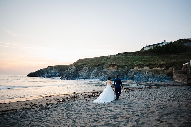 Couple photos along a beach during sunset is so beautiful, is there a better place than the beach at Polurrian On the Lizard?