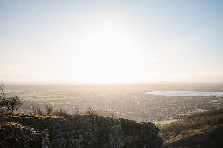 Standing on the cliff edge makes for an epic landscape portrait that you'll want to hang on your wall. By Somerset Engagement Photographer, Jake Timms Photography