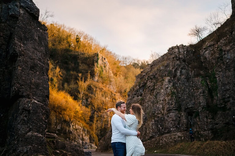 Looking up towards the happy newly engaged couple as the valley at Cheddar Gorge, Somerset, surrounds them