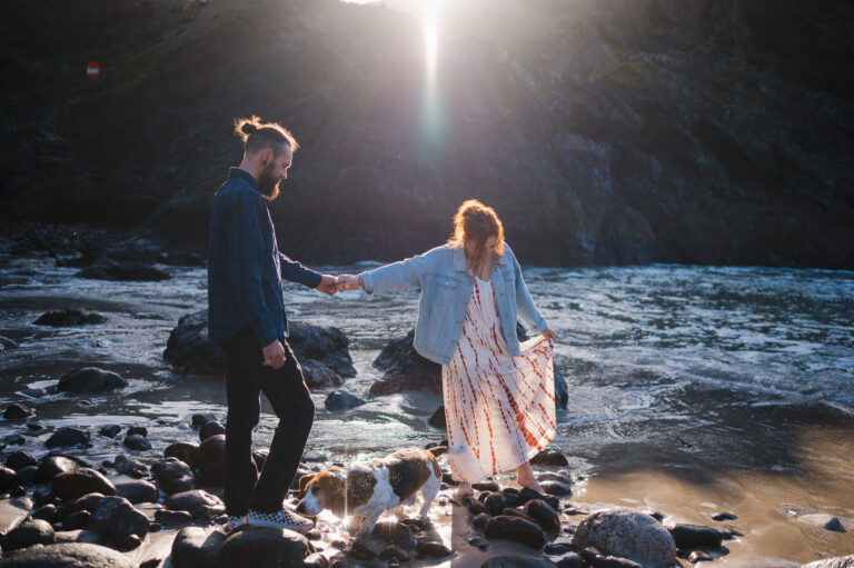 Hand in hand dipping toes in the beautiful water at Kynance Cove