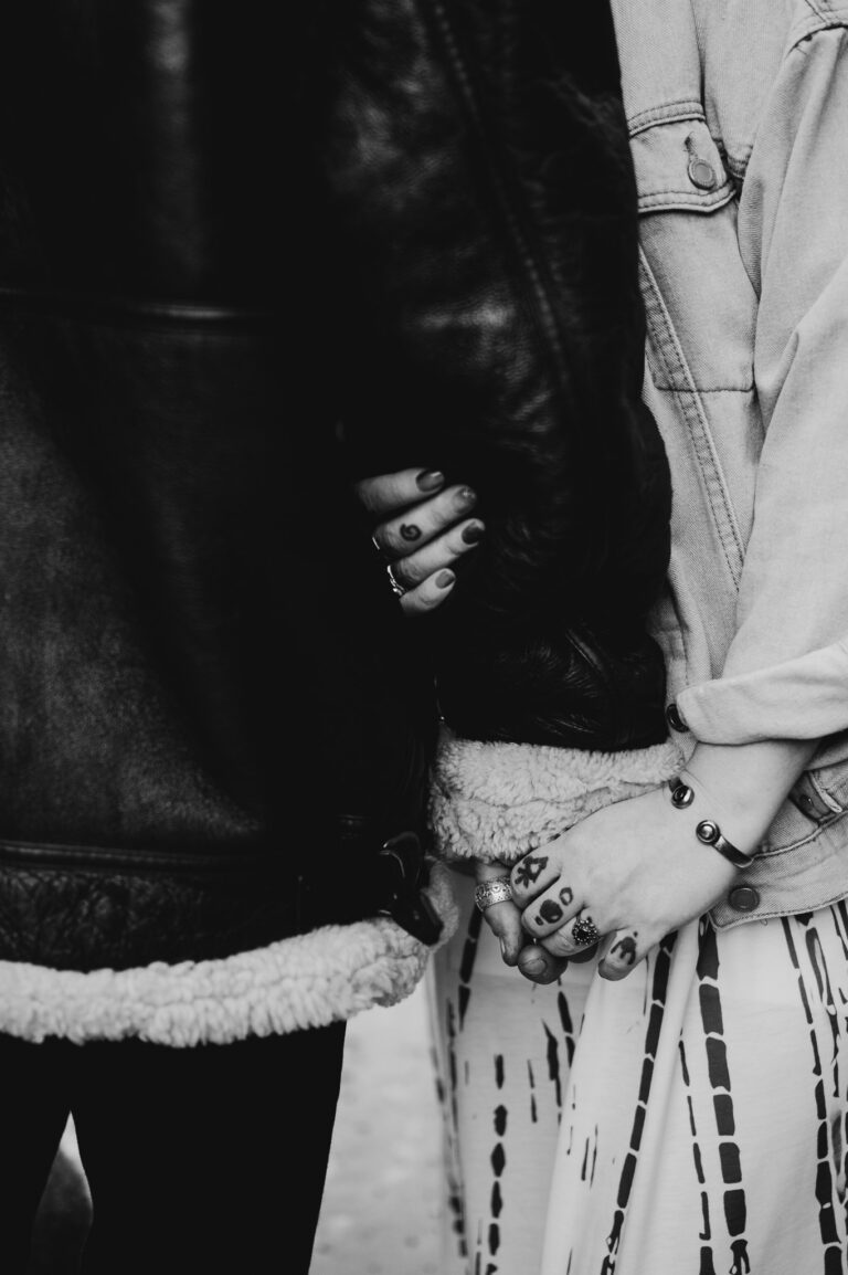 Gripping tight and holding hands showing off their engagement rings