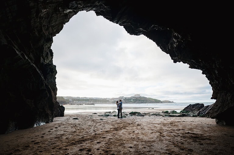 Down the far end of Newquay Beach, you'll find a selection of brilliant caves. The happy newly engaged stand at the entrance way to the caves