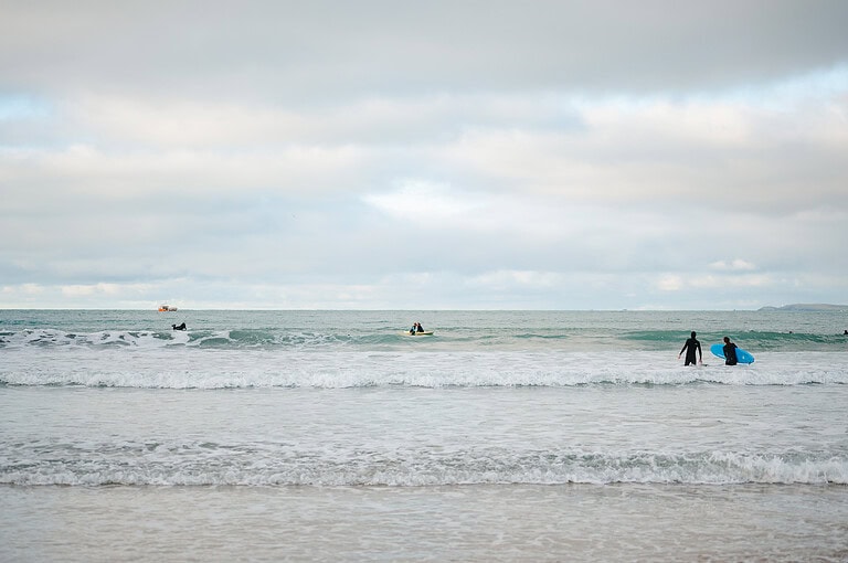 Taking a kiss out at sea on the surfboards in Newquay