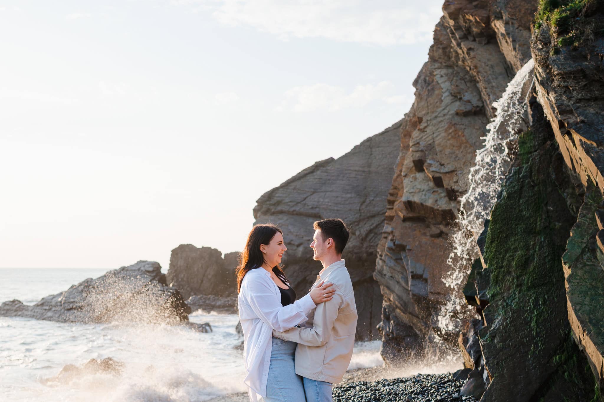 Looking lovingly into each others eyes during their Sandymouth engagement photo shoot