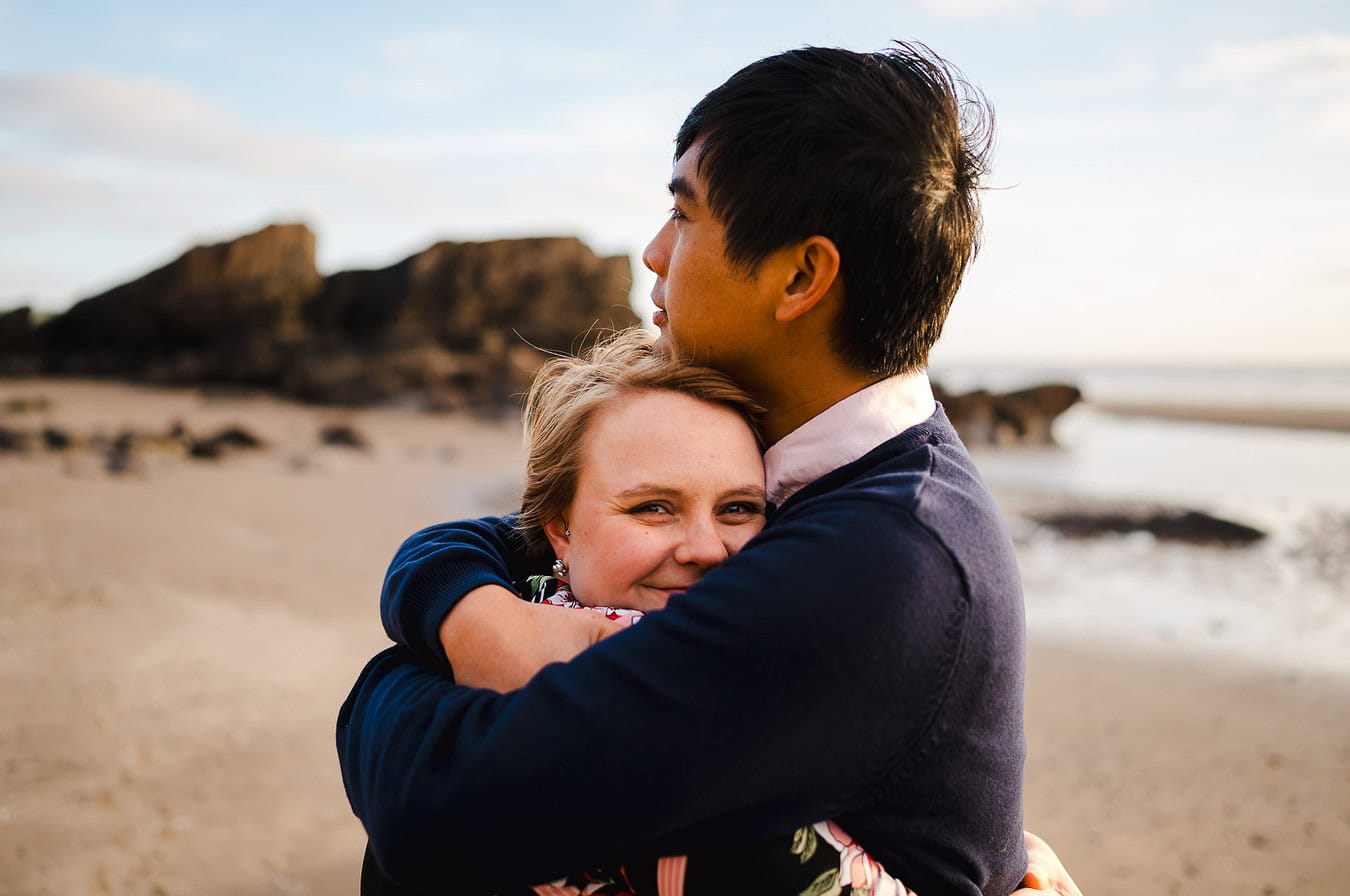 Happiness shared as they hugged during their Whitsand Bay engagement photo shoot