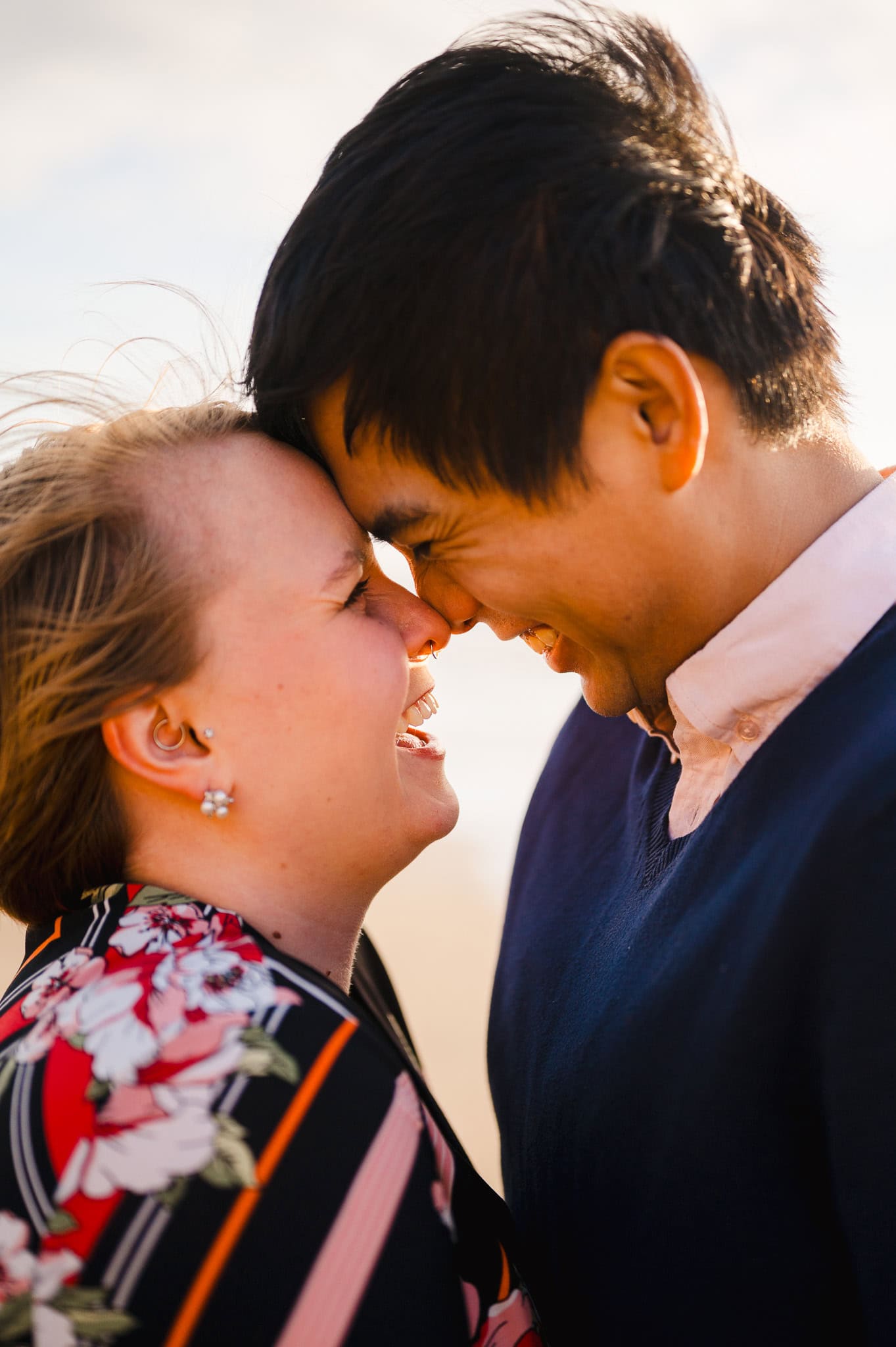 Full of laughter as the happy couple touch foreheads