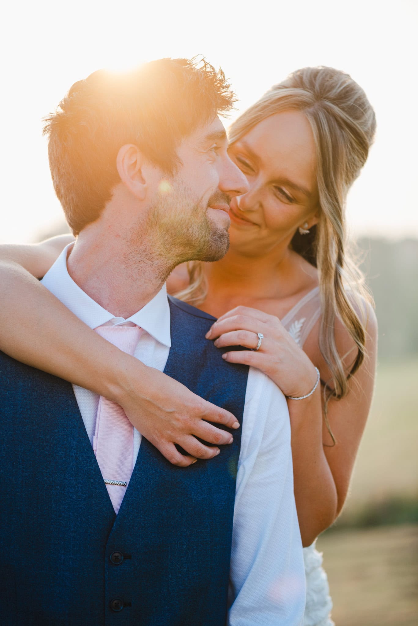 Couple looking lovingly into each others eyes as the golden sun shines behind them by Devon Wedding Photographer Jake Timms Photography