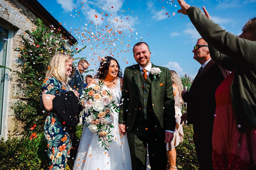 The couple enjoy thier sunny wedding as they celebrate getting married by being covered in wedding confetti by Bath Wedding Photographer, Jake Timms Photography
