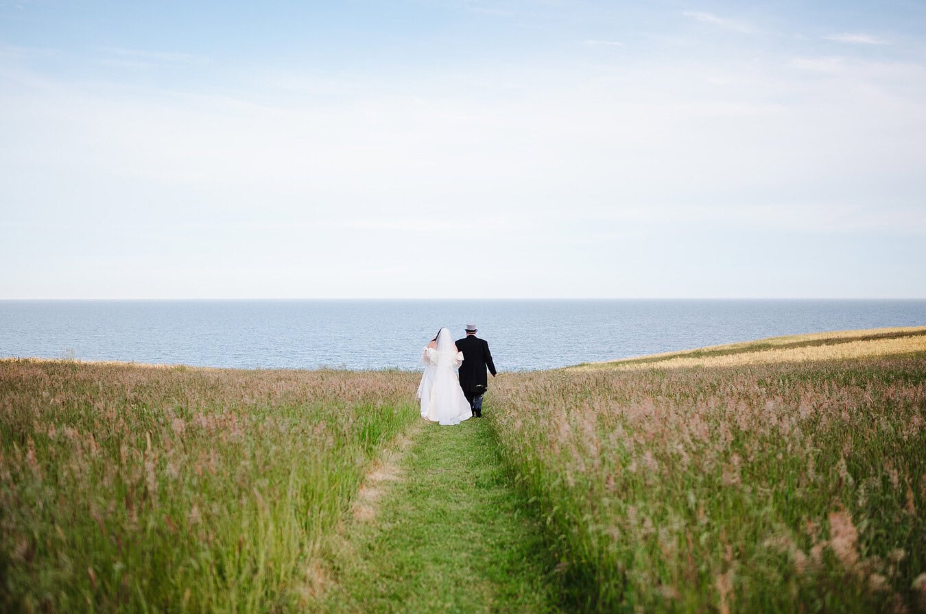The newlyweds walk off into the sunset at the seaside wedding venue by Bath Wedding Photographer, Jake Timms Photography