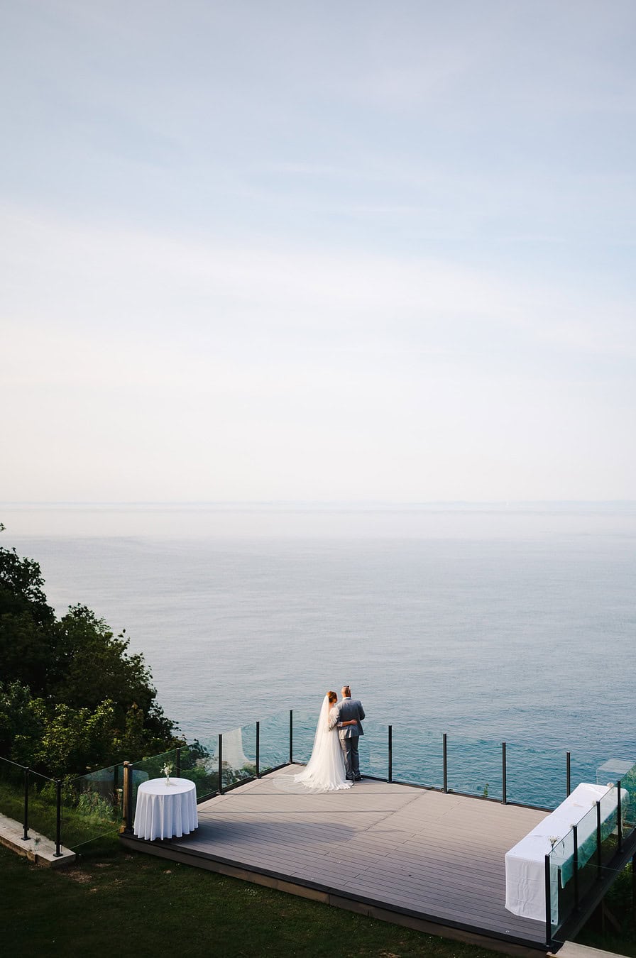 The wedding couple gazes out to the sea from their beautiful wedding venue in Devon by Exeter Wedding Photographer Jake Timms Photography