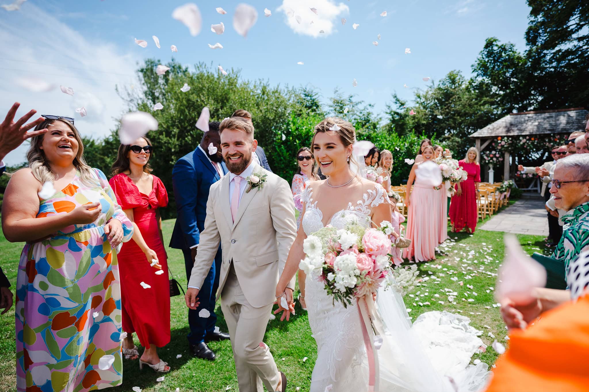 Wedding confetti over the couple as the couple walks on by by London Wedding Photographer, Jake Timms Photography